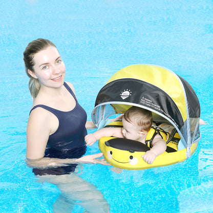 Mother beside her baby in the Bee float in a pool, canopy shading the face