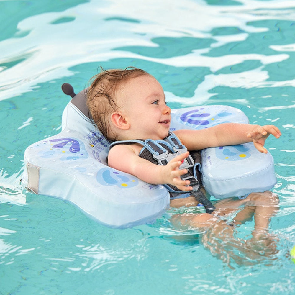 Baby paddling in the Butterfly float, arms resting over the chest pad