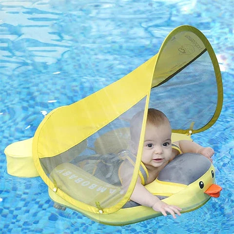 Baby sitting in the Duck float in a pool with the UPF 50+ canopy up