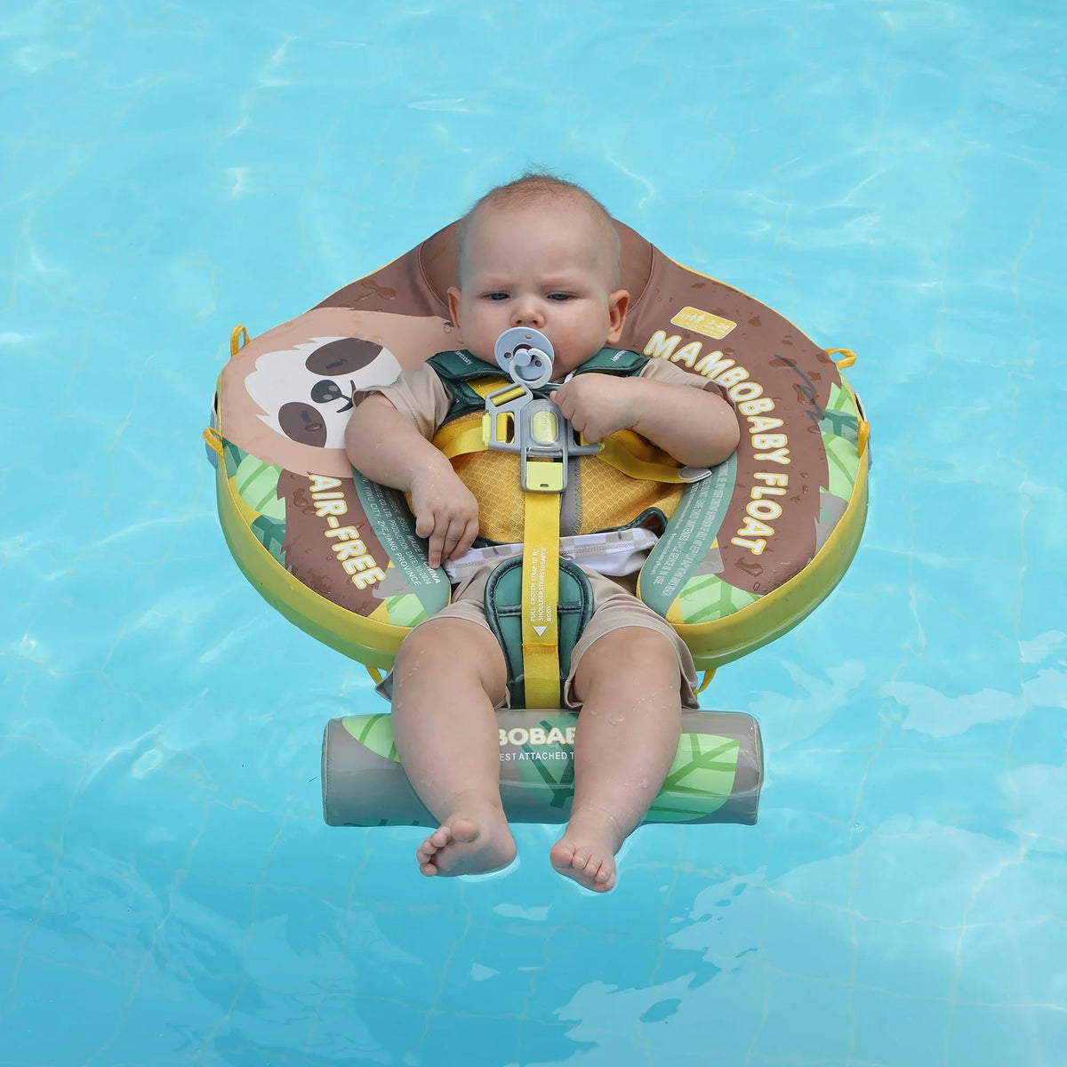 Baby facing forward in the Mambobaby Sloth float, harness fastened