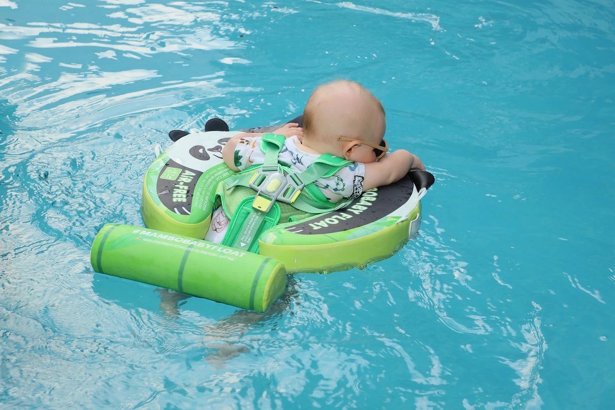 Baby floating on their back in the Mambobaby Panda float — backstroke position for 3–12 months